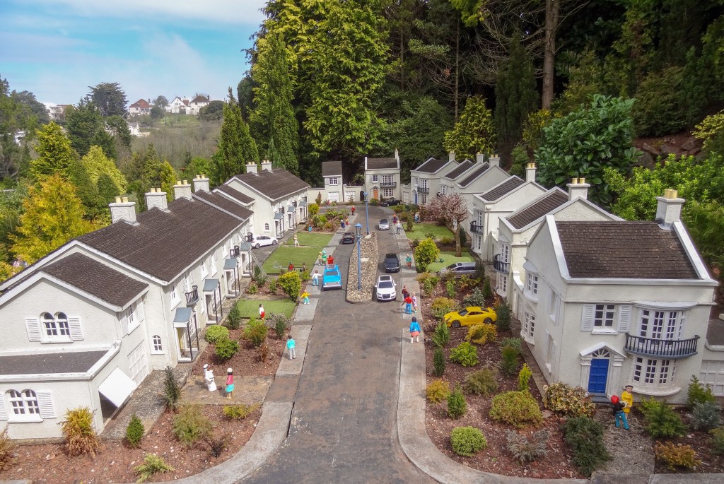 model of cul de sac full of two-story homes and children playing on the sidewalks